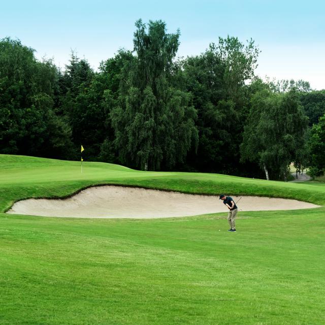 Man on golf course.